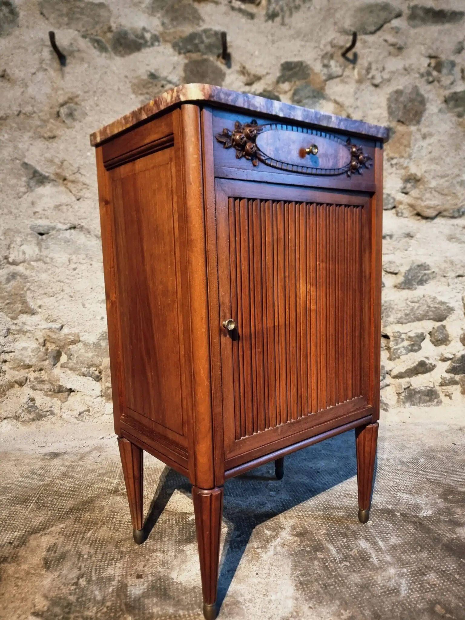 French antique bedside table in walnut with a marble top and porcelain interior, early 20th century.