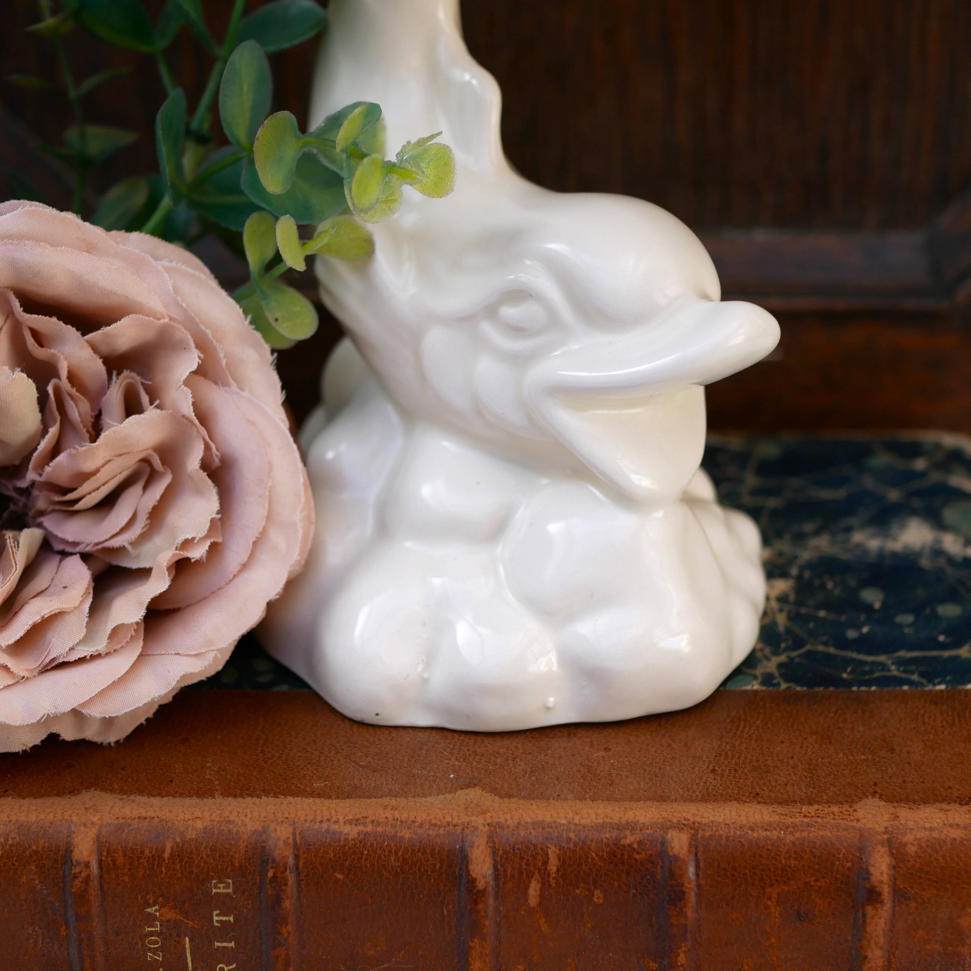 Dartmouth pottery koi carp supporting a shell-shaped dish/vase.