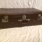 Suitcase vintage leather inside and brown carpeted home