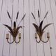 Brass wall lights with a bouquet of reeds by FlorArt.