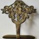 Decorative coat hook with cherubs/putti in aged brass.