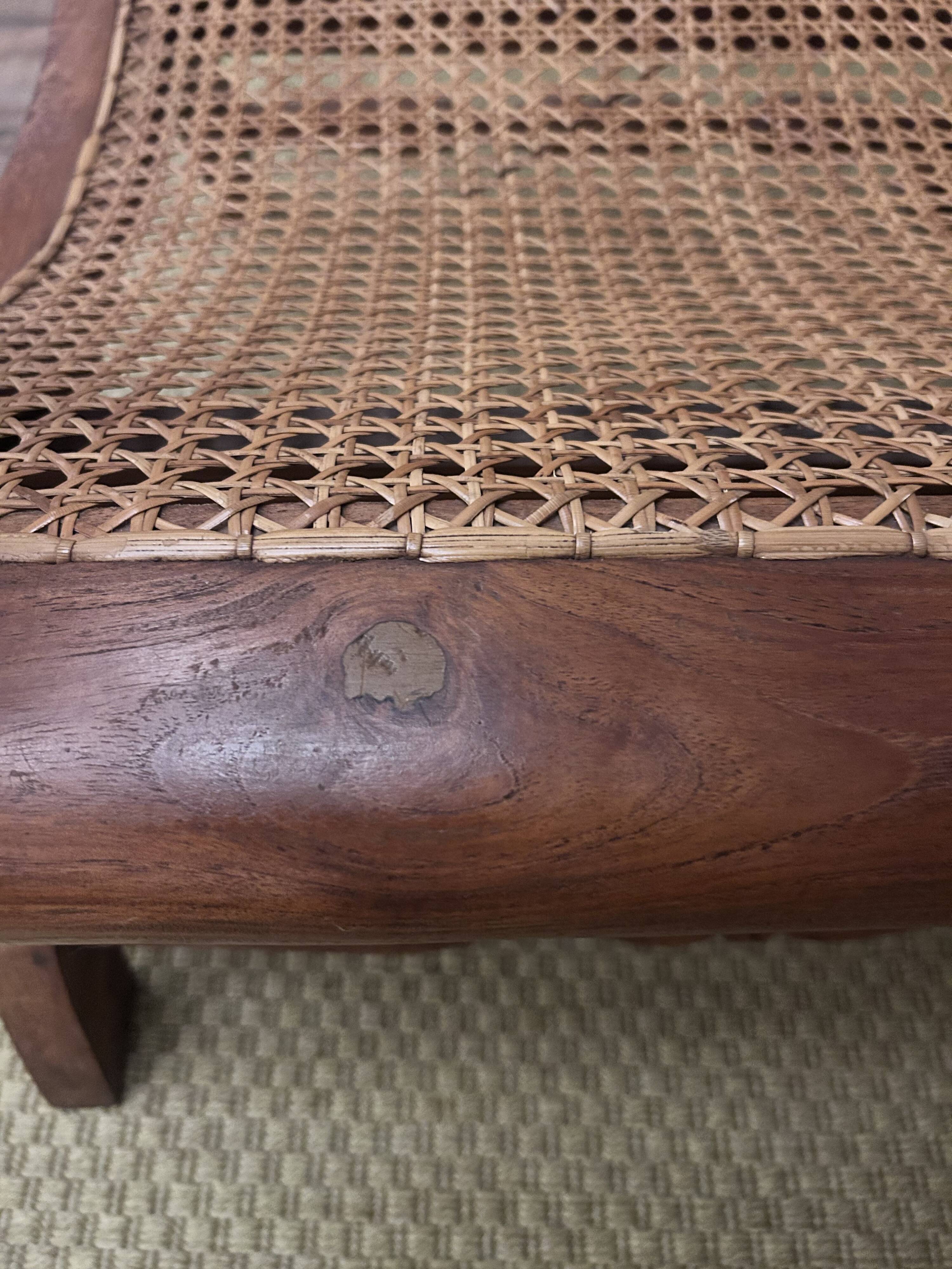 Colonial planter's armchair in solid teak, scroll armrests, caned seat.