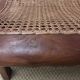 Colonial planter's armchair in solid teak, scroll armrests, caned seat.