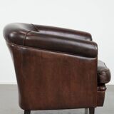 Dark brown vintage club armchair in English style made of sheepskin leather