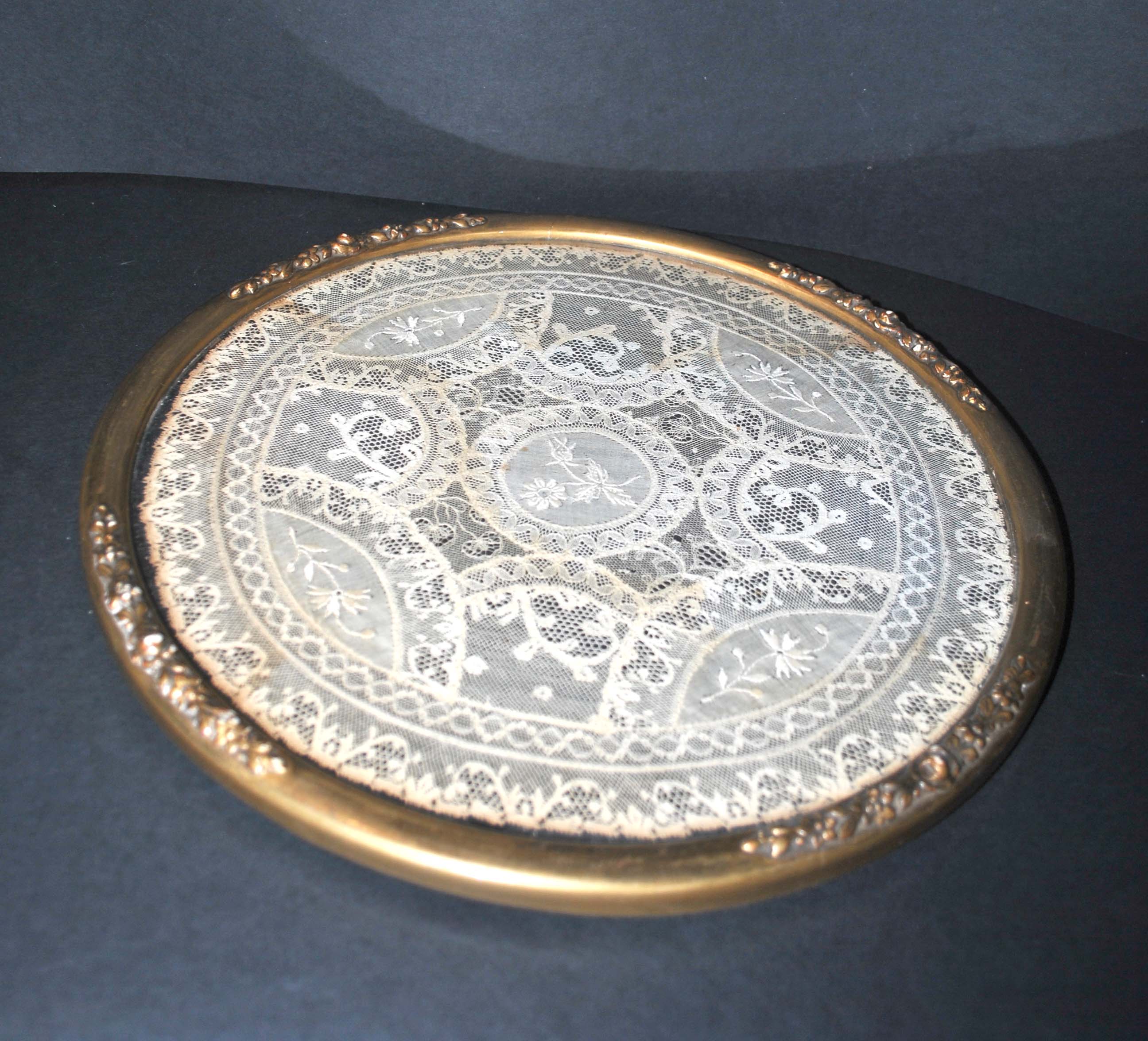 Antique lace top under glass and gilded stucco frame