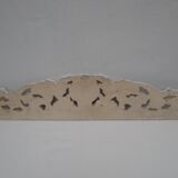 Decorative pediment in white carved wood