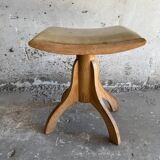 Vintage natural wood stool with light yellow faux leather seat and crossed splayed base