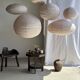 Average suspension in natural rattan and linen, Japanese-style, flattened oval in pink.