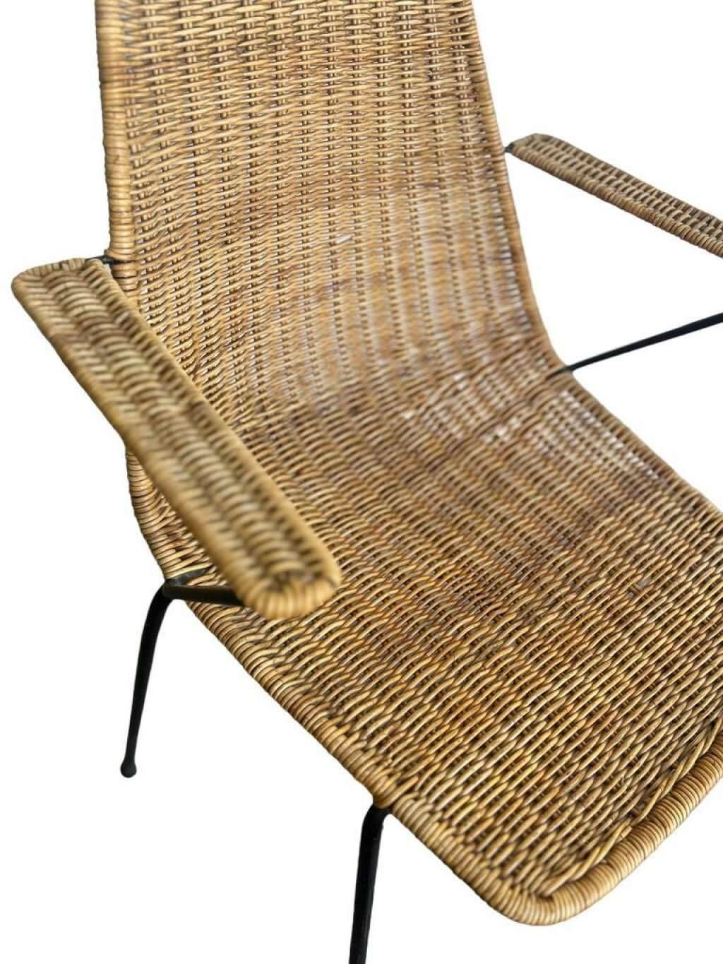 Vintage wicker chair with black steel frame and armrests