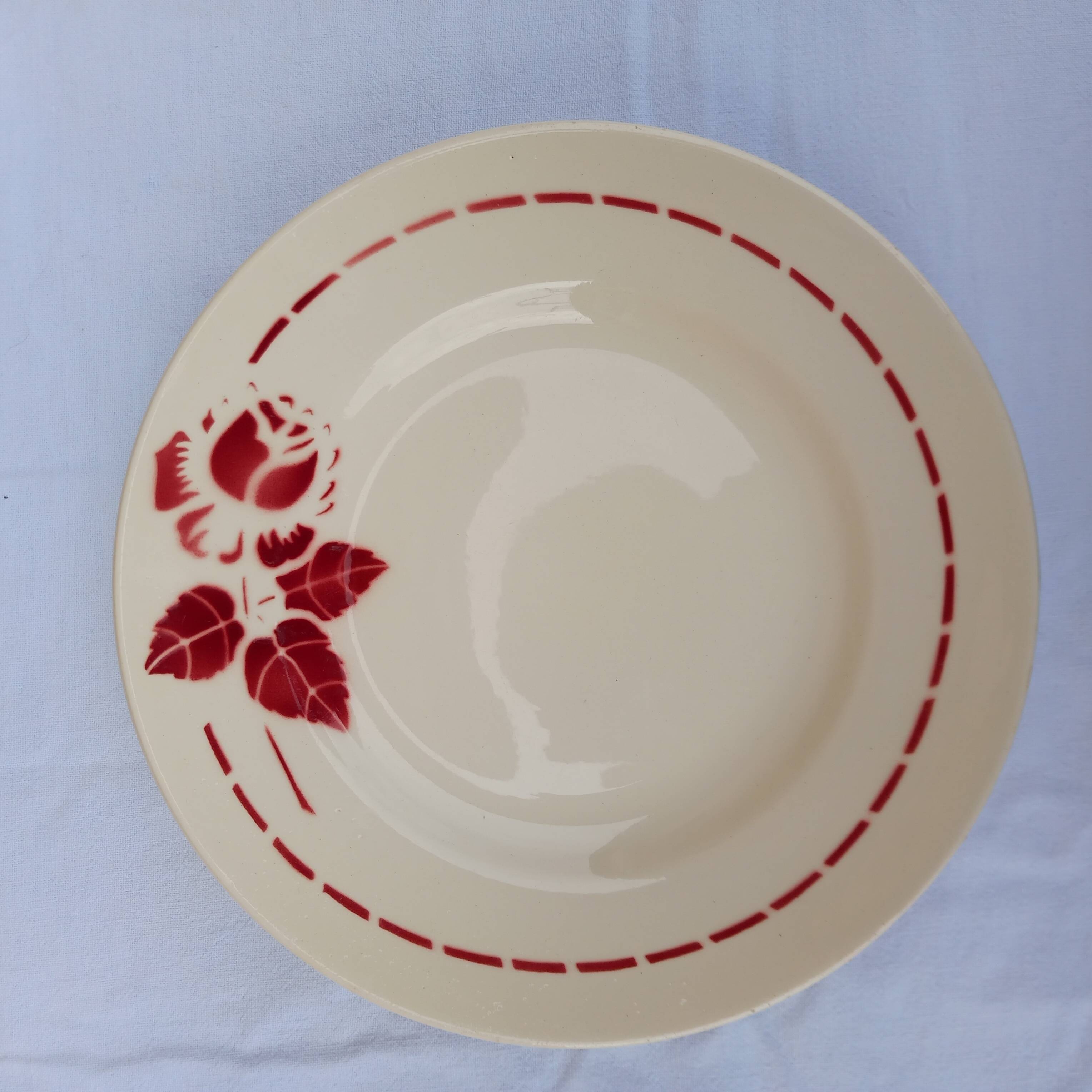 Old presentation plate on red rose foot