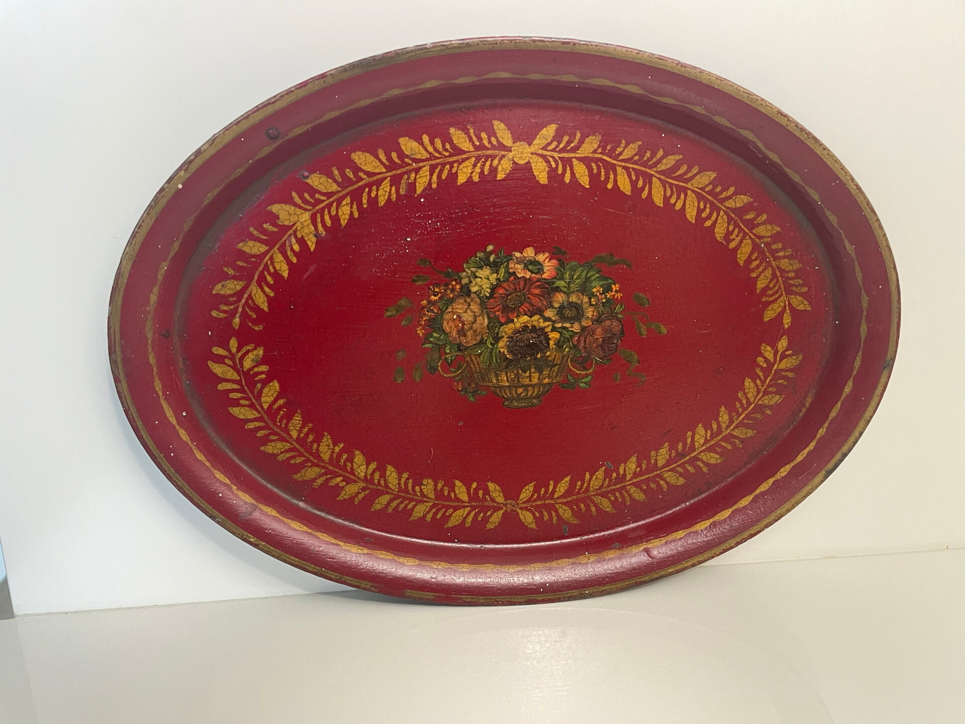 Old oval plate in painted red tin - floral decoration - early 20th century -