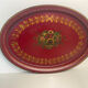 Old oval plate in painted red tin - floral decoration - early 20th century -