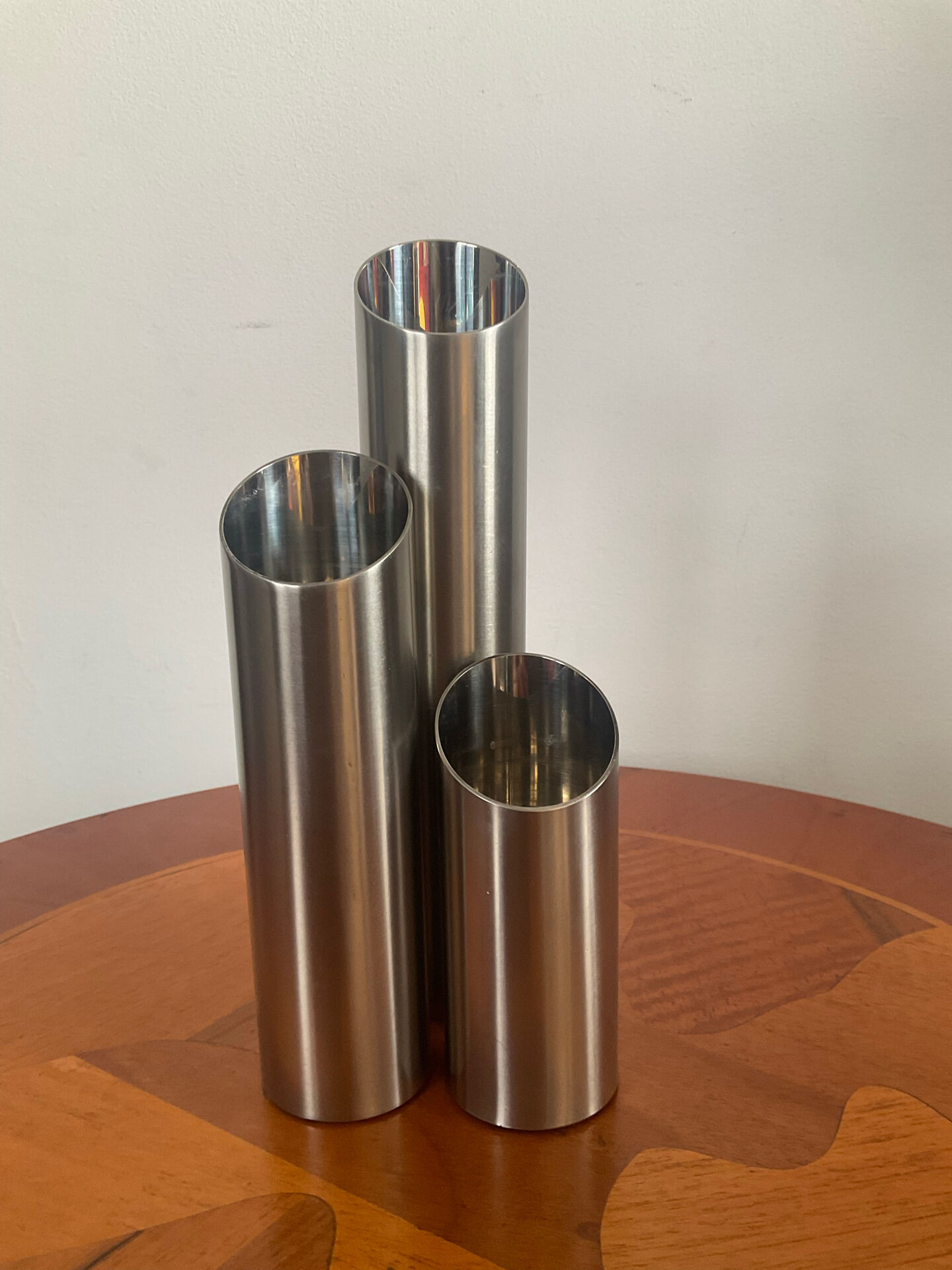 Vintage trio of brushed stainless steel candle holders