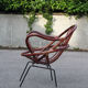 Rattan shell armchair with metal feet