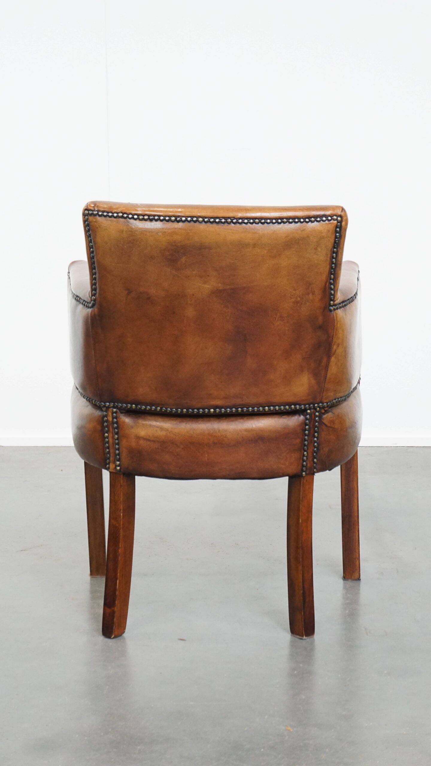 Amazing cognac-coloured sheepskin dining/side chair with armrests