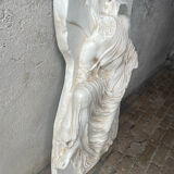 Ancient plaster bas-relief of Nike fastening her sandal.