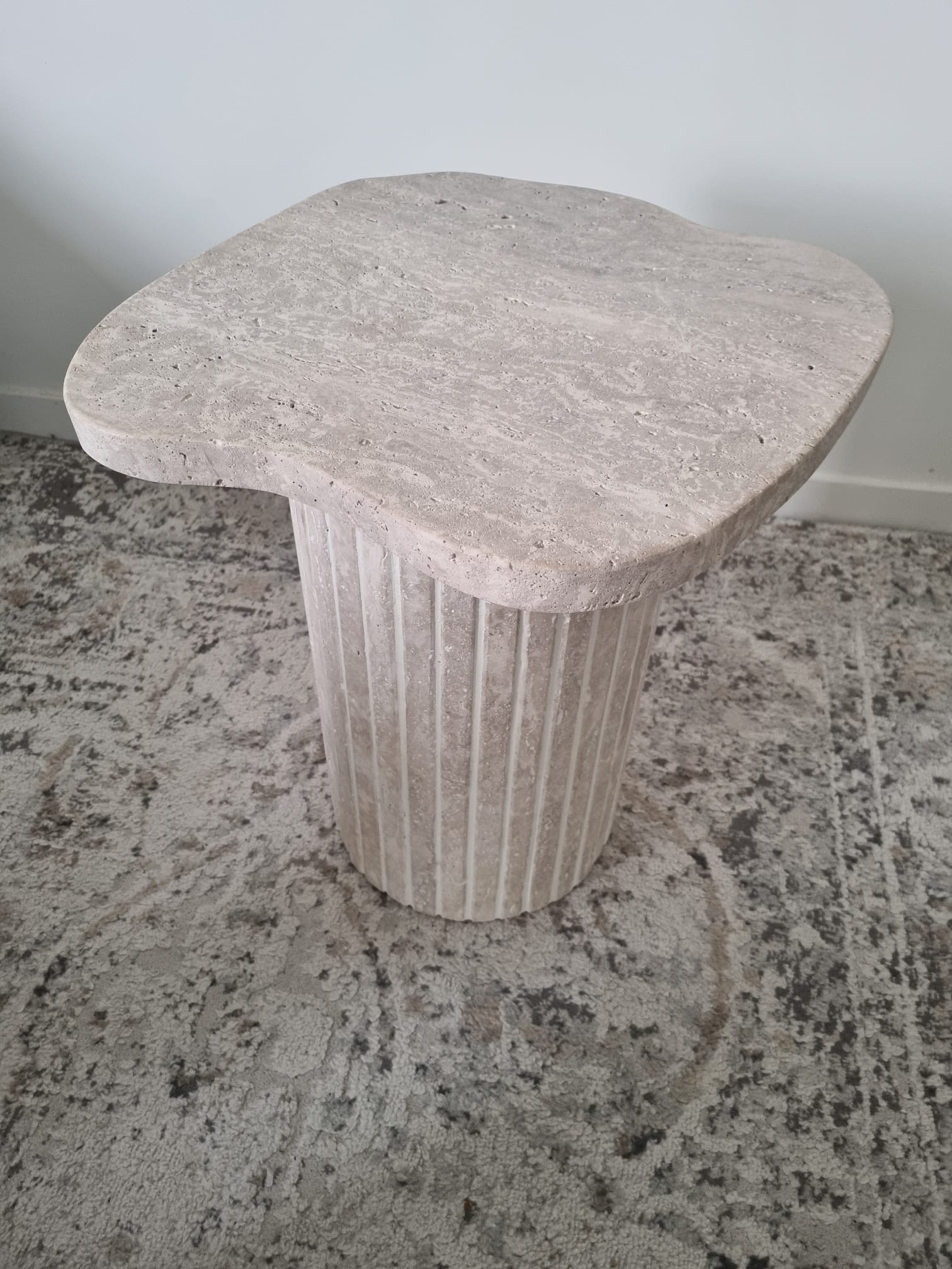 Alpha side table irregular natural travertine ribbed foot