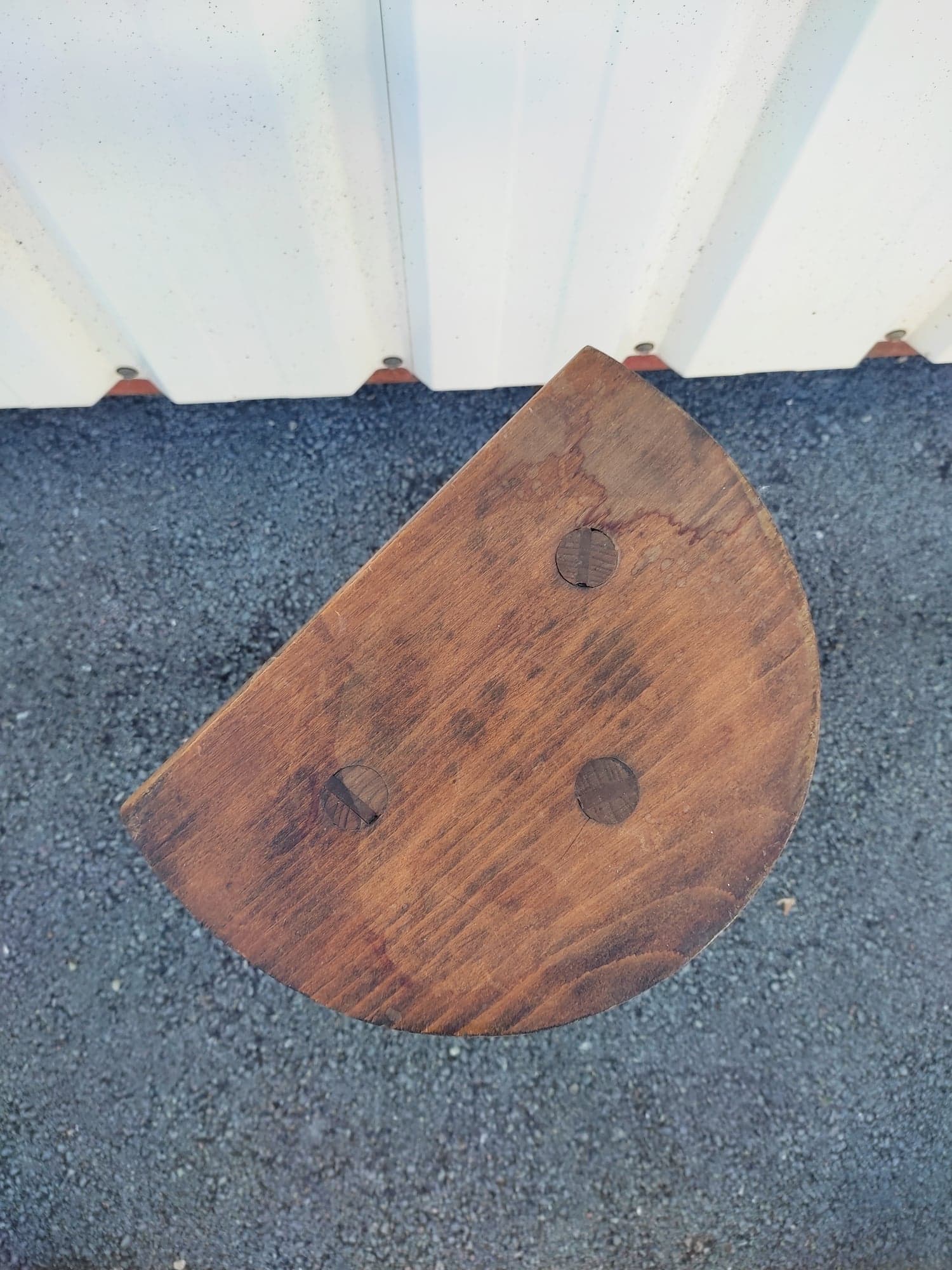Pretty wooden stool with half moon seat and turned wooden tripod base