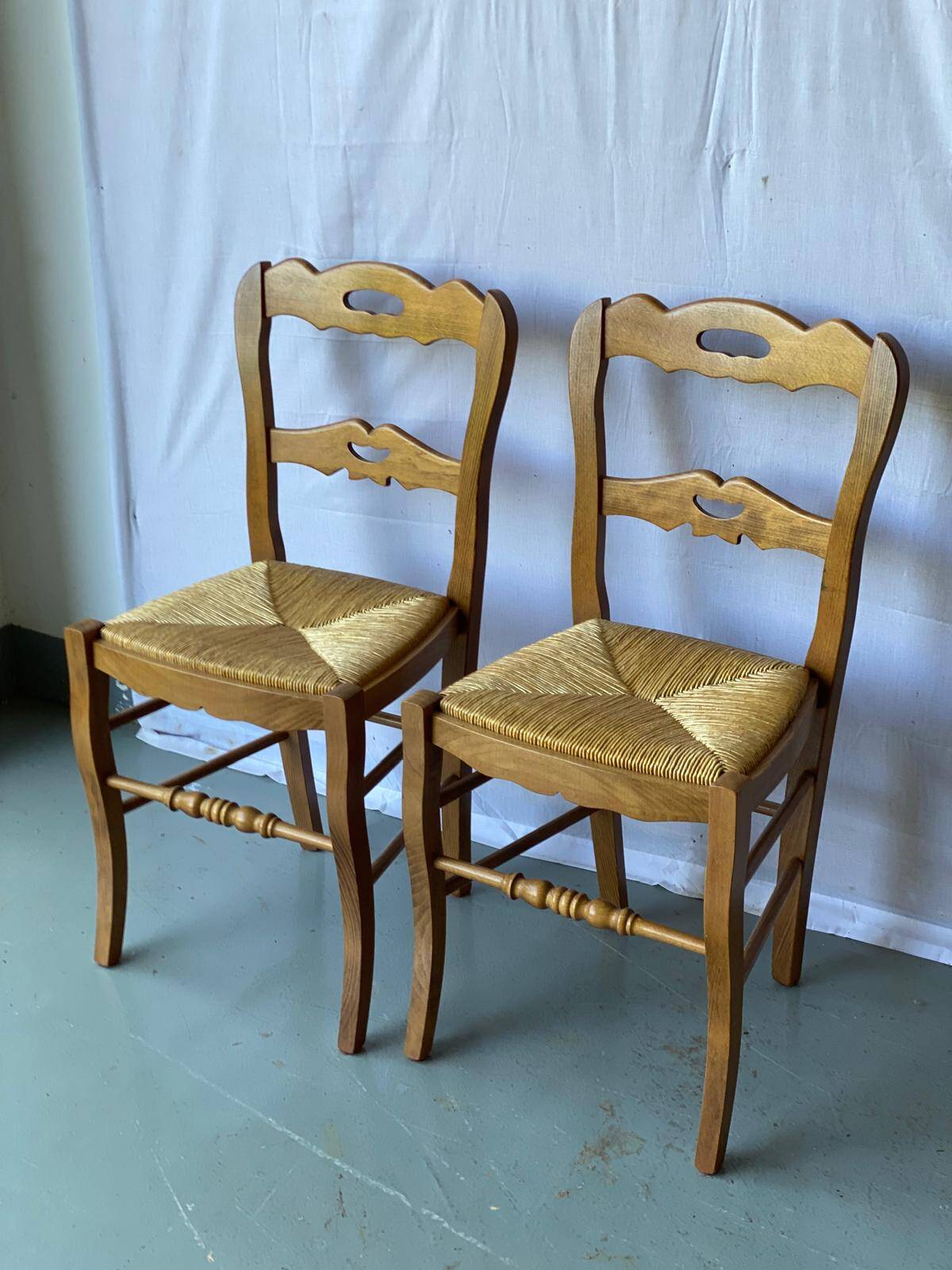 2 solid wood and straw dining chairs
