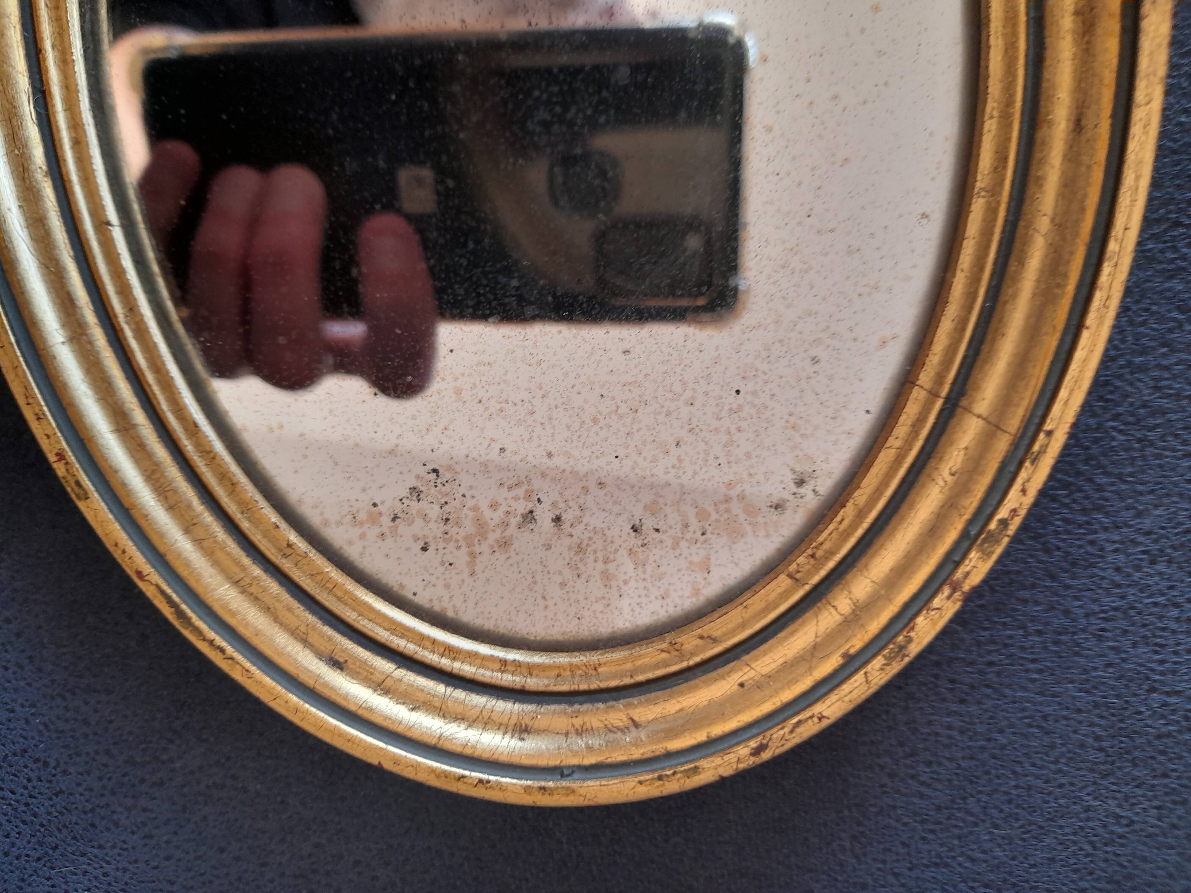 Old golden oval mirror