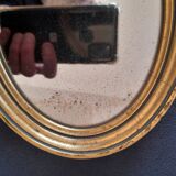 Old golden oval mirror