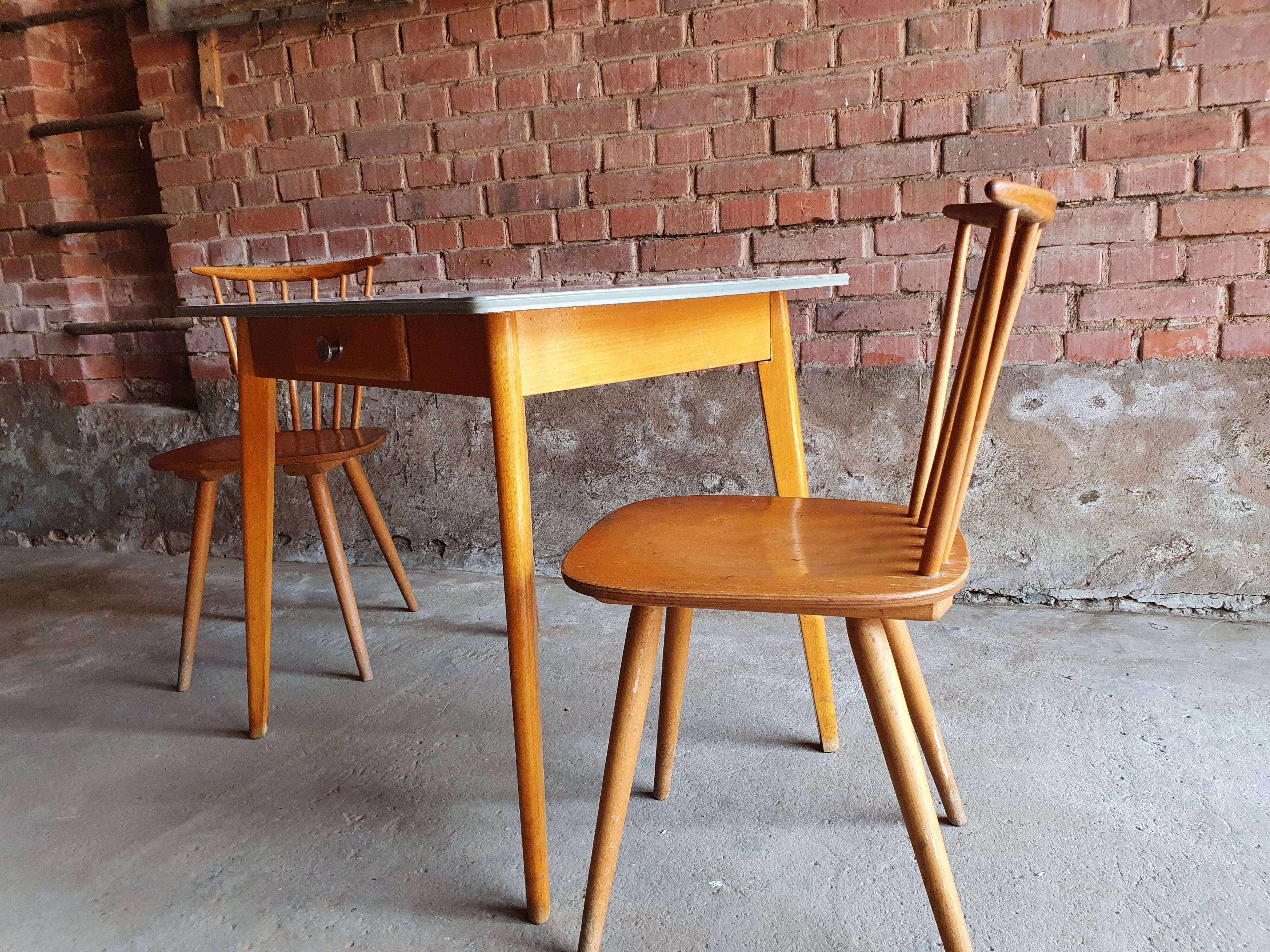 Together two Scandinavian chairs and its wooden and formica table