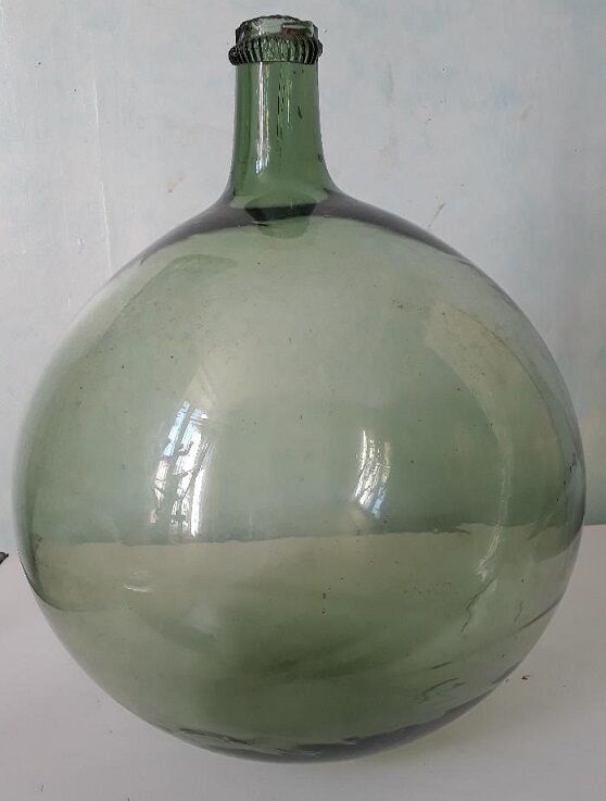 Old blown glass demijohn
