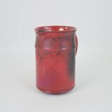 Red glazed ceramic jug with relief