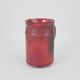 Red glazed ceramic jug with relief