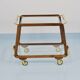 May include: A mid-century modern bar cart with a dark wood frame and two c