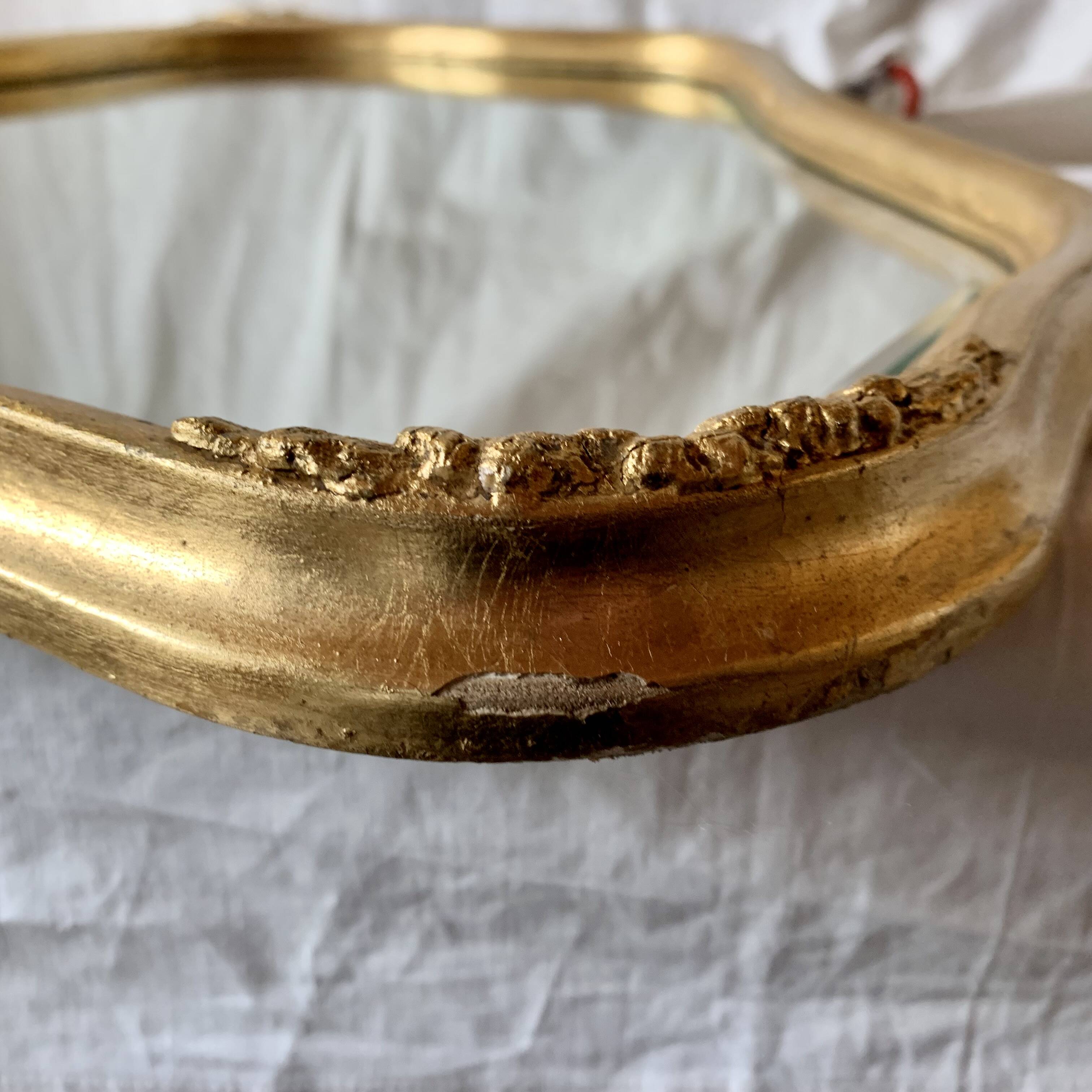 Antique beveled wall mirror in gilded solid wood