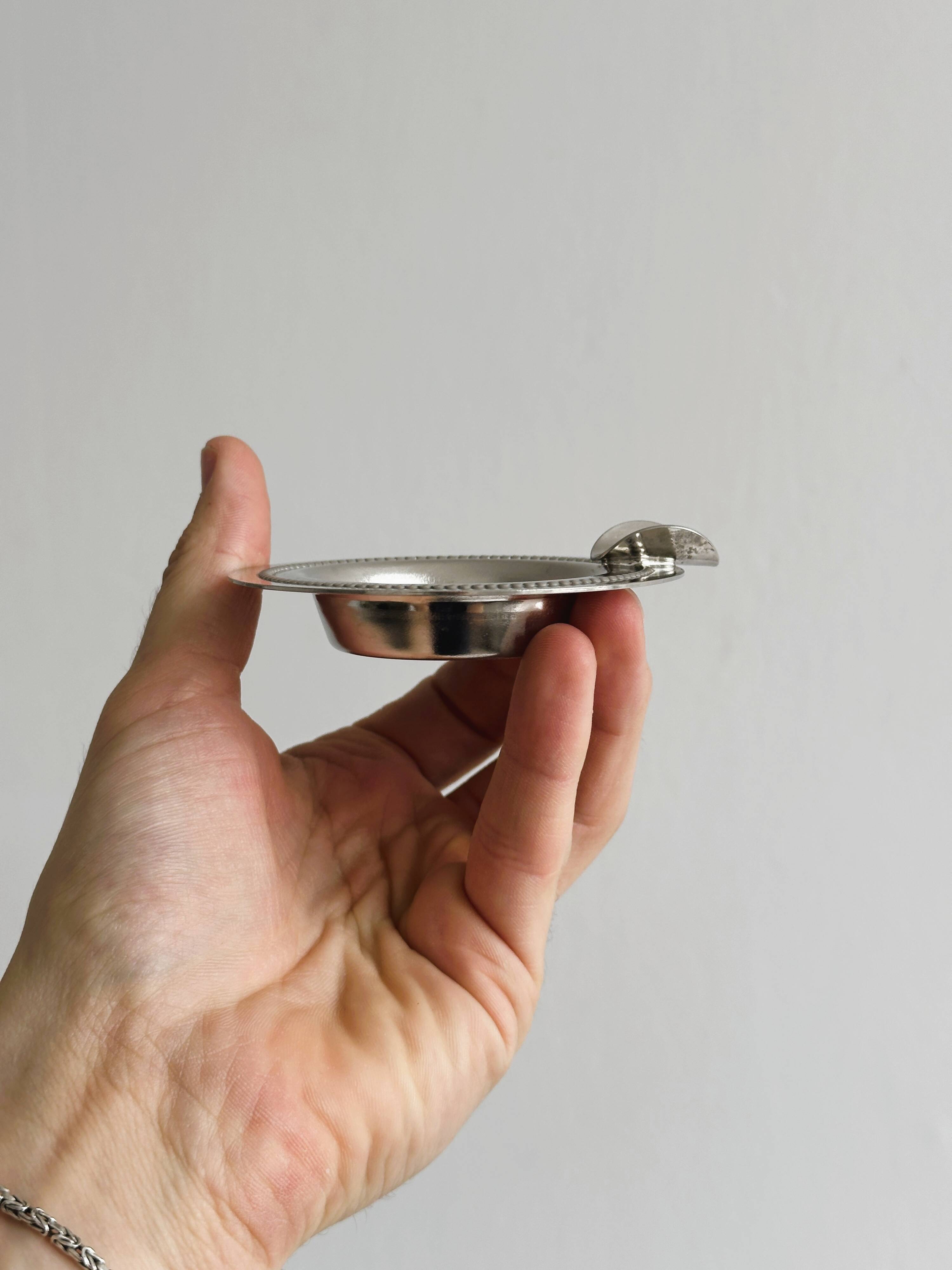 Small ashtray in shiny silver metal