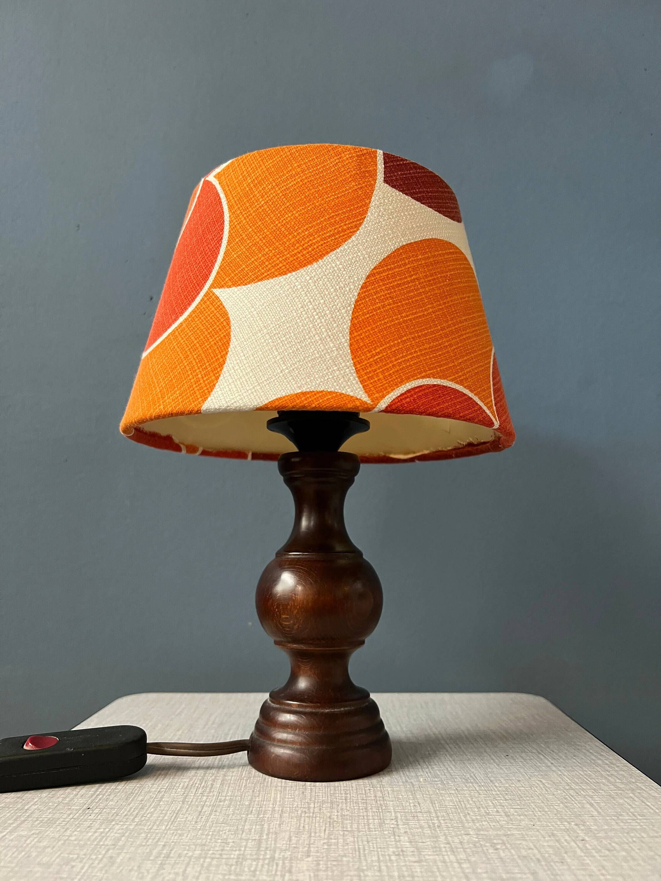 Vintage Space Age table lamp with orange fabric shade.