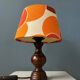Vintage Space Age table lamp with orange fabric shade.