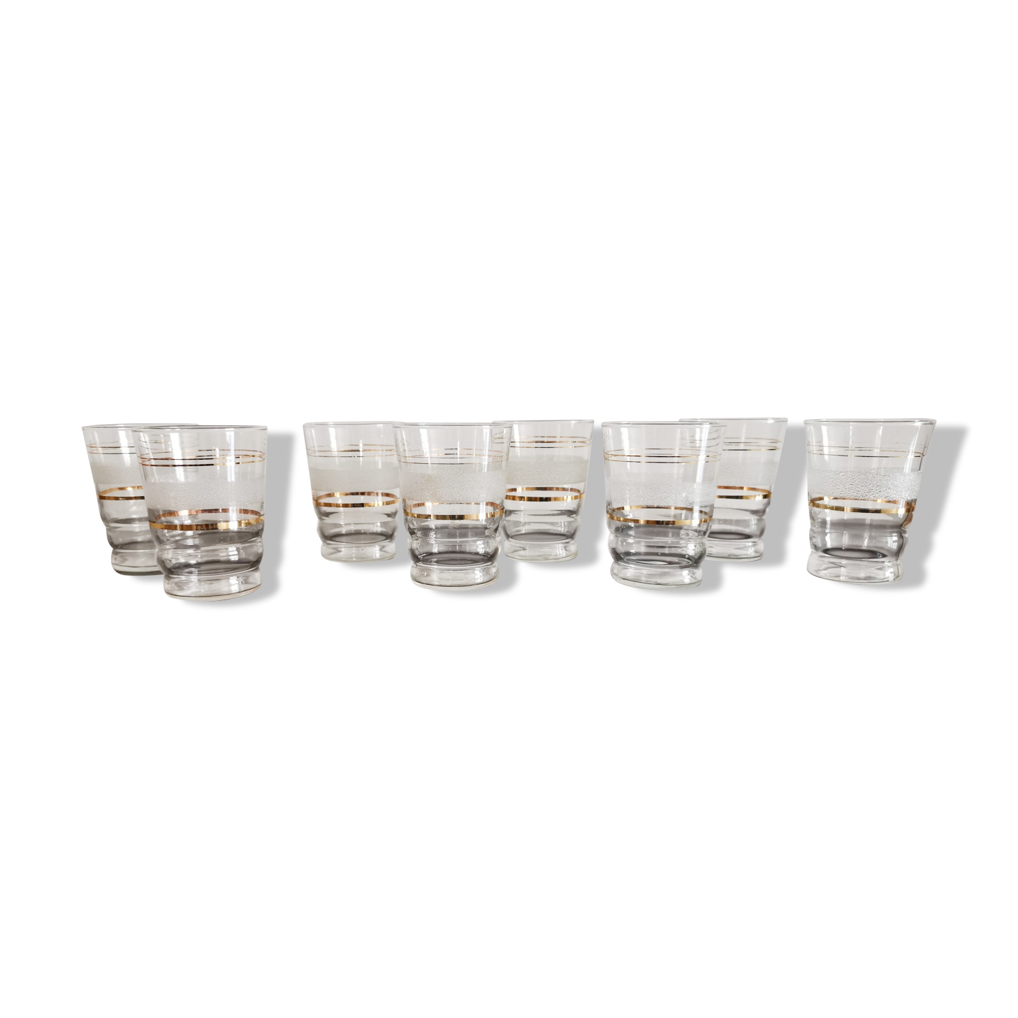 8 glasses with white granite band and gold edging from the 1950s