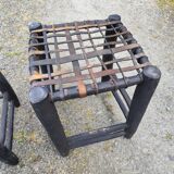 5 blackened wooden stools with woven leather seats by Nina Kaufmann