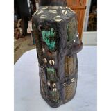 African statue of a woman, made of wood, brass, beads, and seashells.