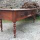 Old farmhouse table with cherry and chestnut panels with 3 drawers.