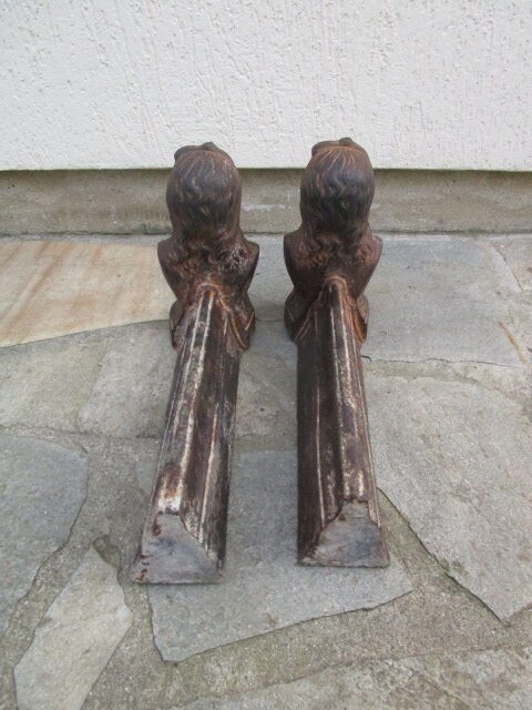 Pair of antique women's head cast iron chenets