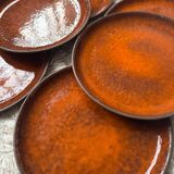 Orange glazed ceramic plates from the 1970s