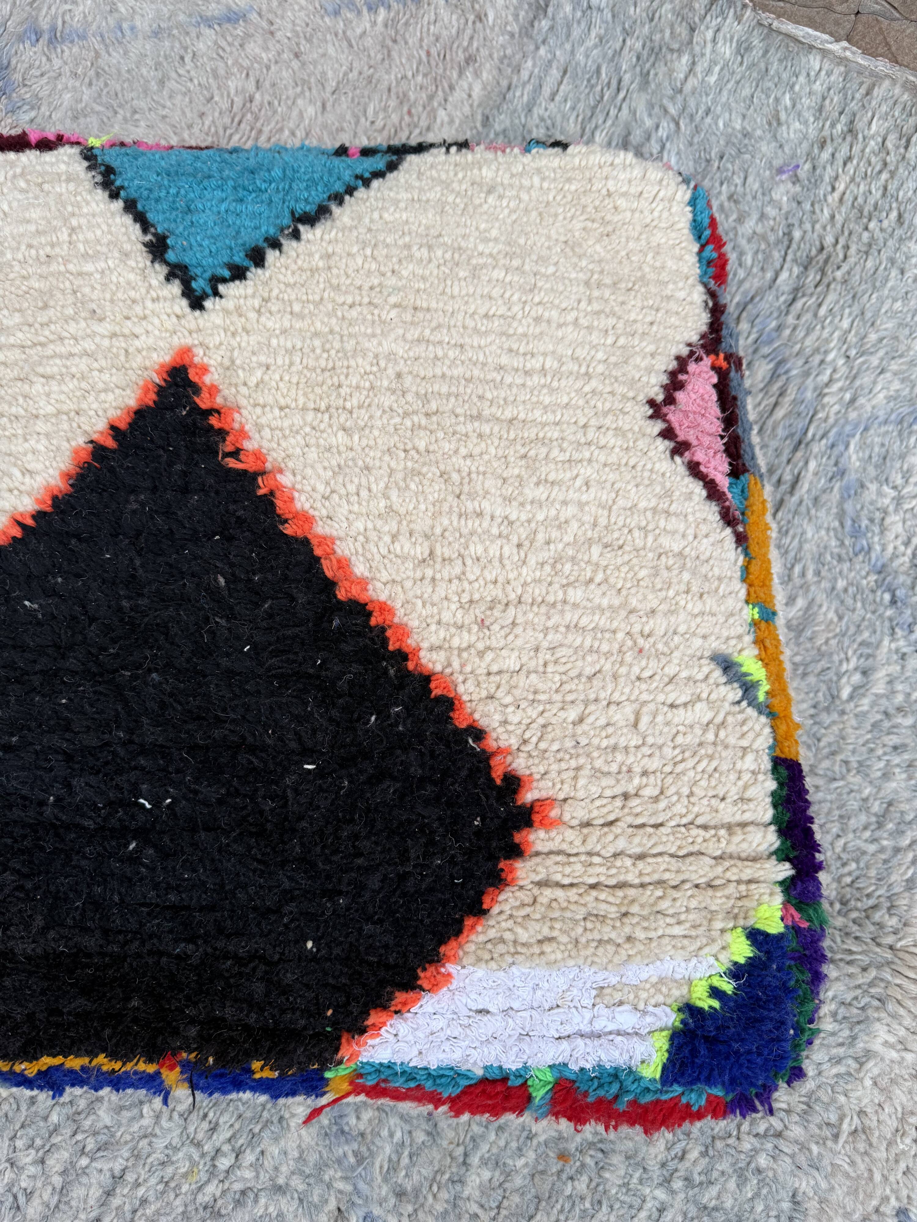 Berber floor pouf: Handwoven Moroccan wool cushion.