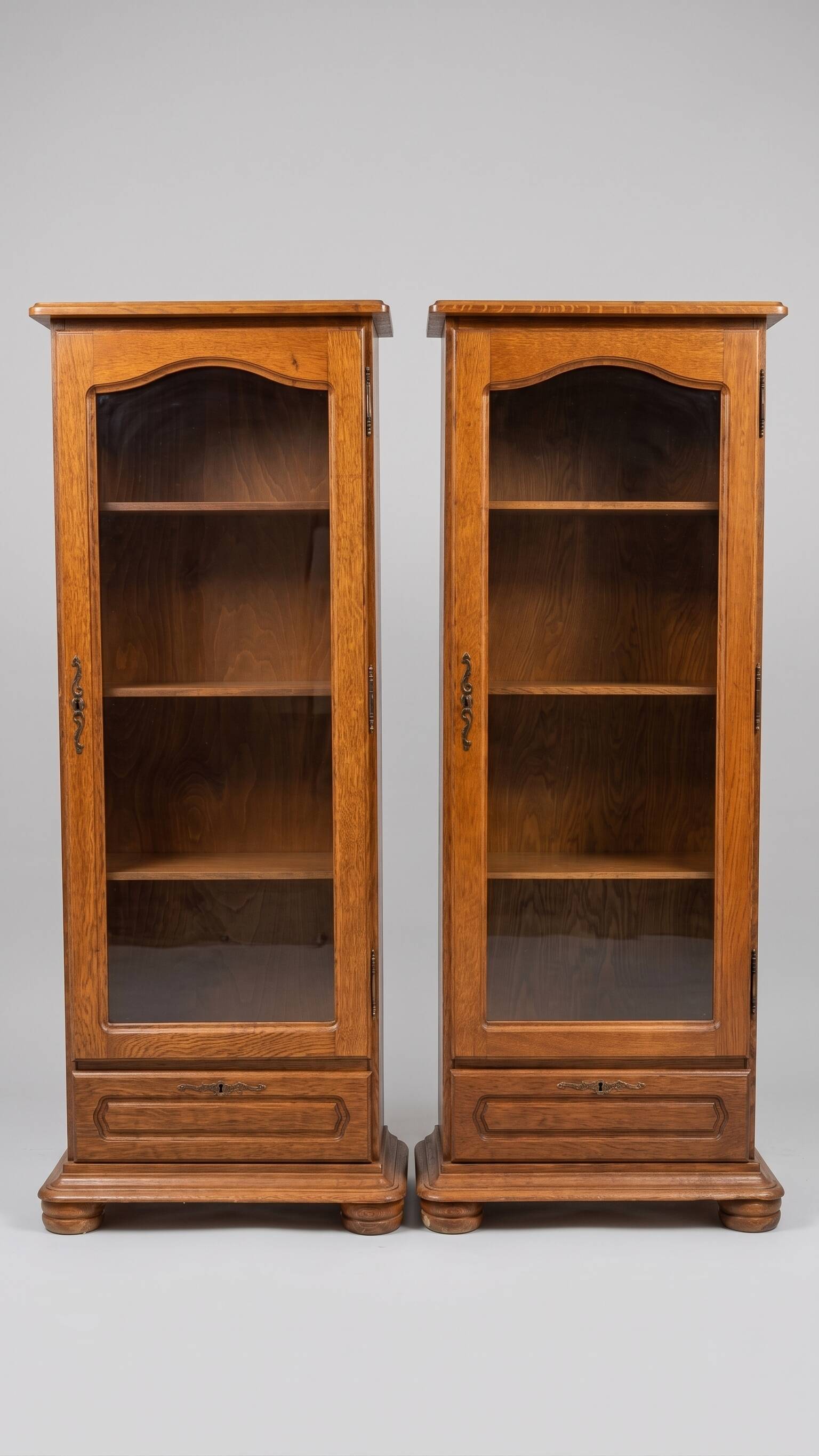 Set of 2 solid wood display cabinets with glass doors.
