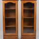Set of 2 solid wood display cabinets with glass doors.