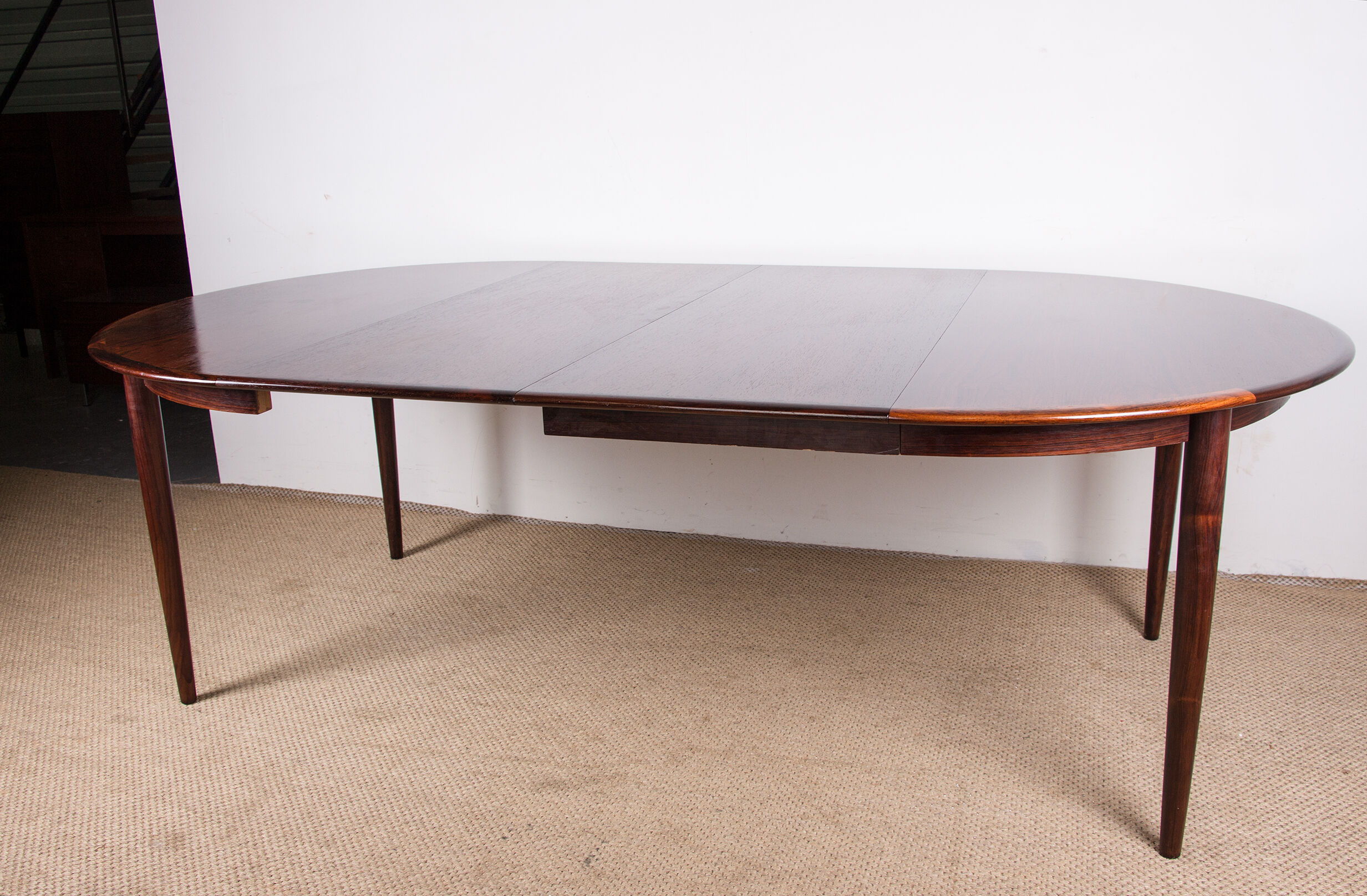 Danish extendable dining table in Rio Rosewood model 55 by Arne Vodder for Sibast 1958.