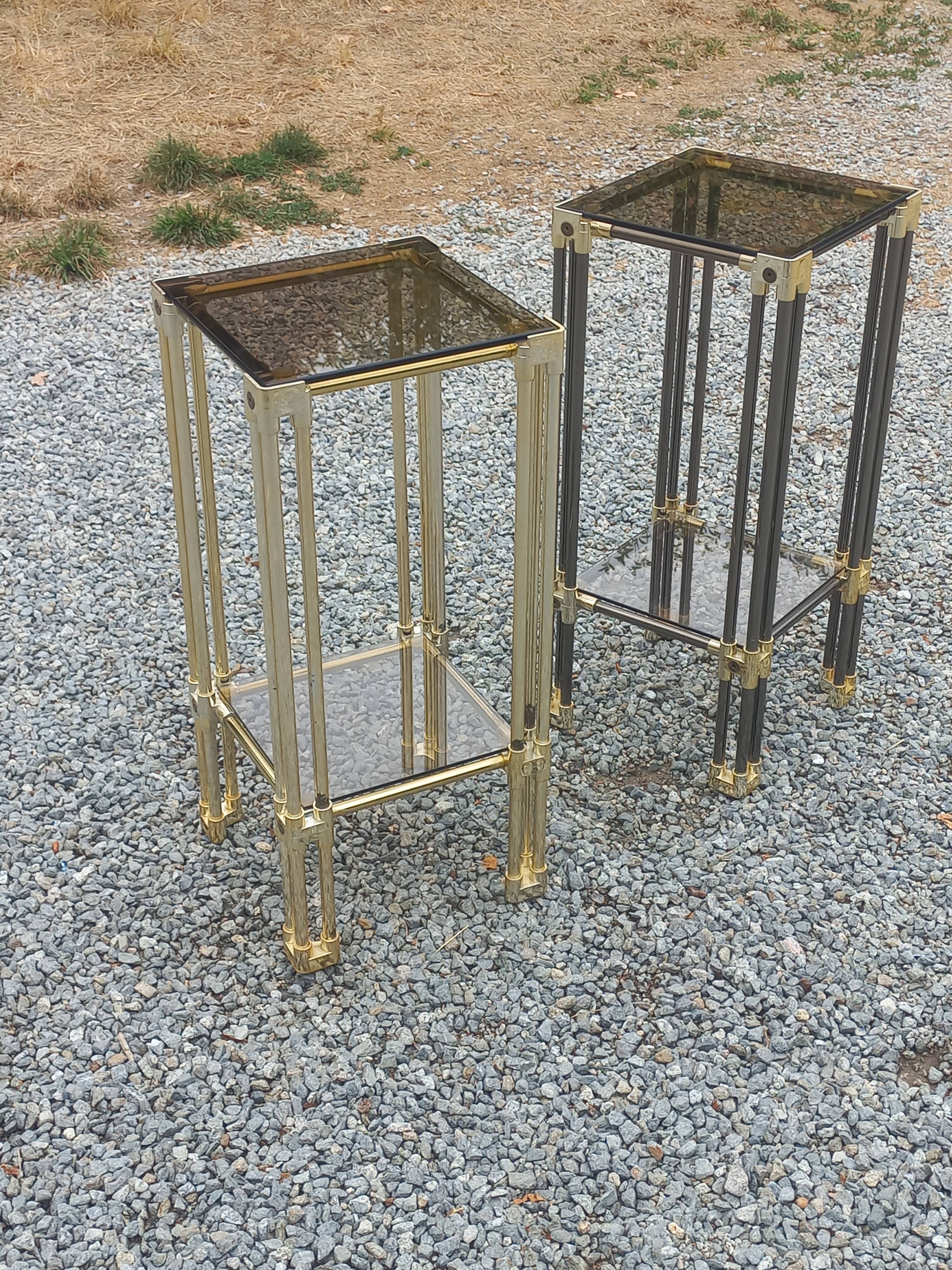 Pair of Hollywood Regency side tables in gold metal and smoked glass.