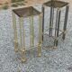 Pair of Hollywood Regency side tables in gold metal and smoked glass.