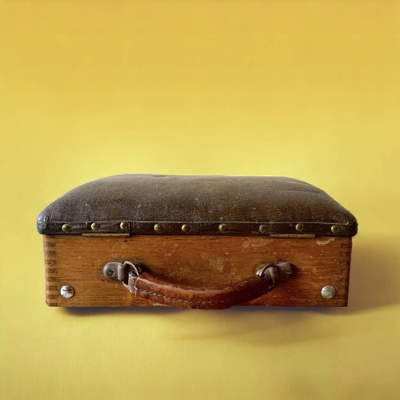 Old foldable fisherman's stool in wood and leather