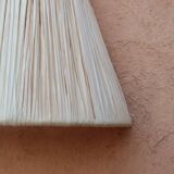 Handmade conical raffia wall light