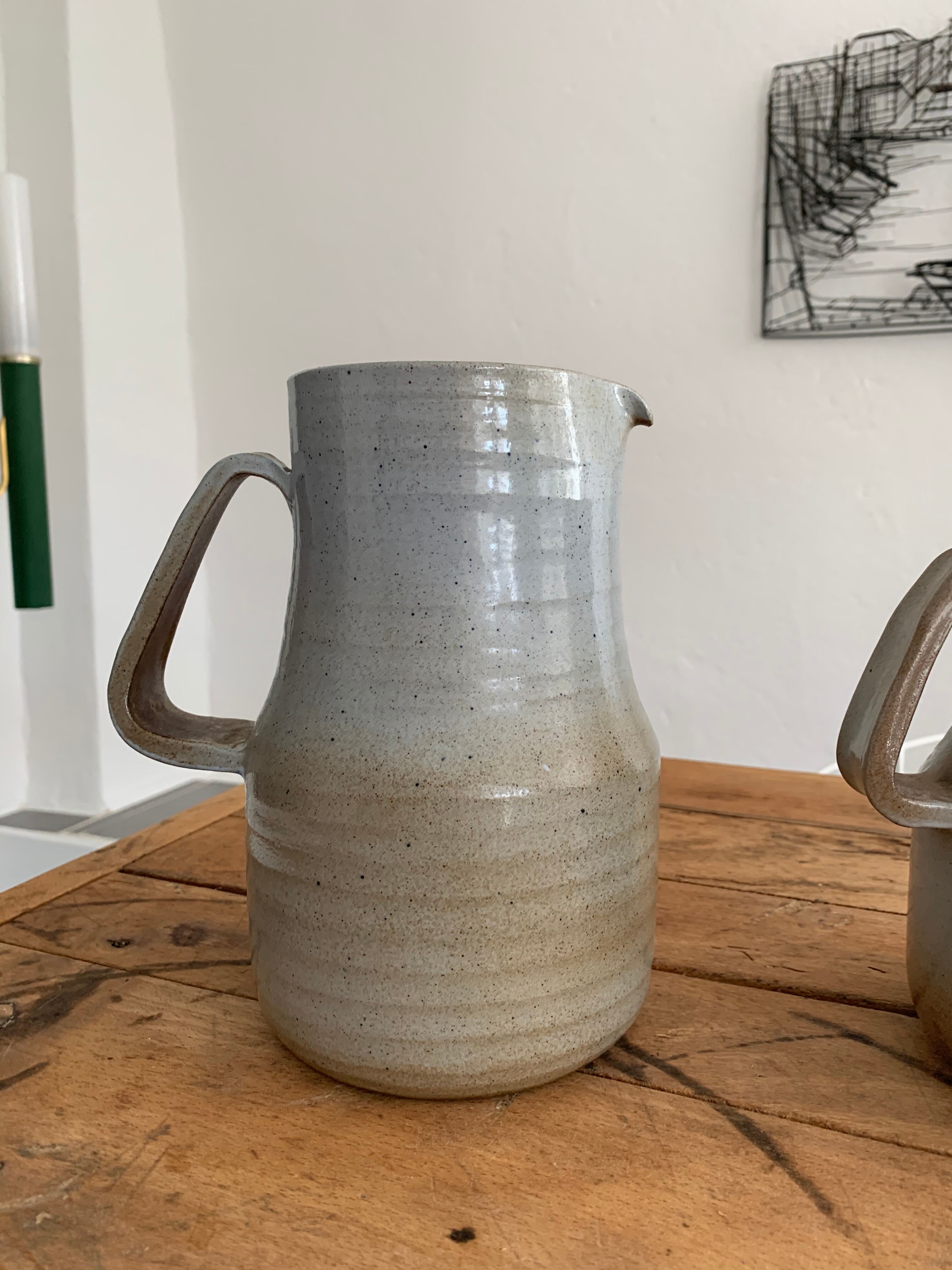Pair vintage enamelled ceramic pitchers