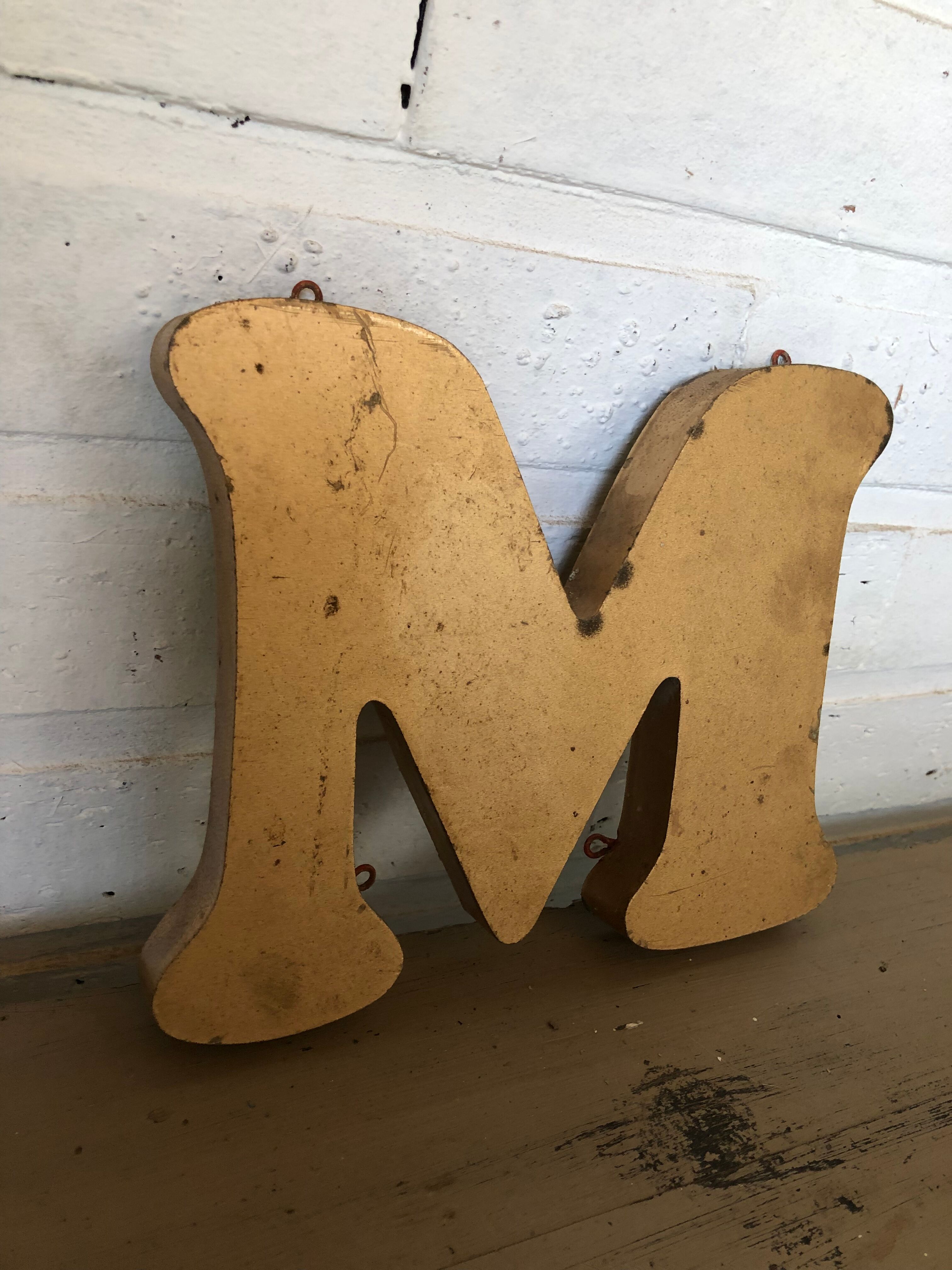 Golden sign letter "M"